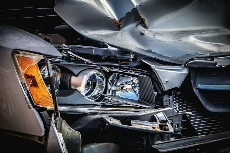 Car with a crushed hood and broken headlight after a collision